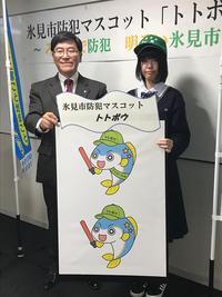 市長と女学生が魚のマスコットが描かれたパネルもっている写真